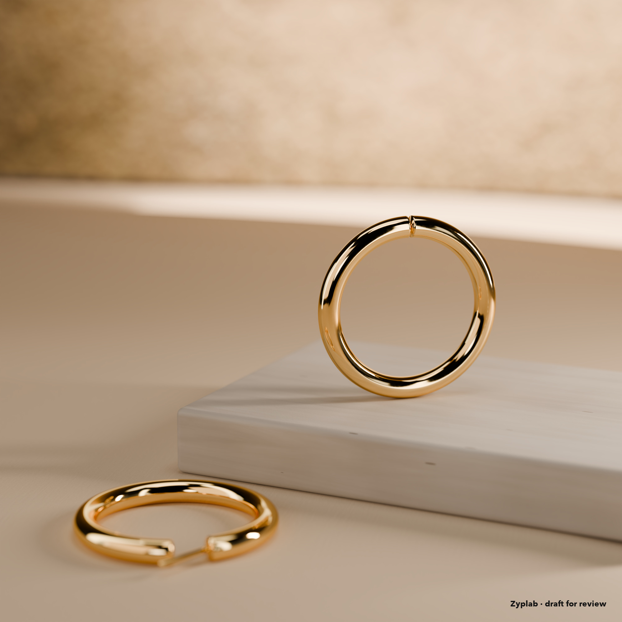 Pair of 18k gold hoop earrings on limestone and linen